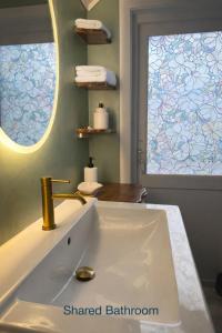 a bathroom with a white sink and a window at Alfa Room - The LOWFO House Lofoten in Moskenes +53 photos