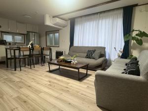 a living room with a couch and a table at Guest house LIA1 in Abashiri