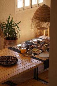 a wooden table with plates of food on it at The Line Up in Mirleft +40 photos