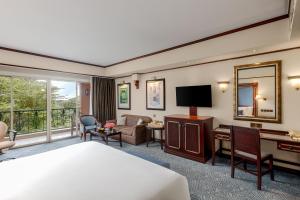 a hotel room with a bed and a desk at Kampala Serena Hotel in Kampala