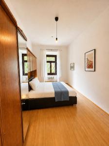 a bedroom with a bed and a window at NUMBR25 - self service & low budget Hotel in Graz