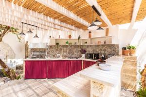 a large kitchen with a red counter top at Dimora Ferente in Salve