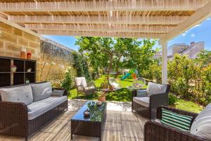 an outdoor patio with couches and a table at Dimora Ferente in Salve