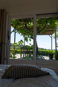 a bedroom with a bed and a window with a view at Atelier n°5 in Wanze