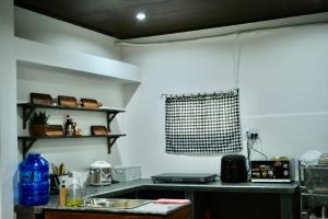 a kitchen with a sink and a counter top at Outdo'r Garden House in Tuy Hoa
