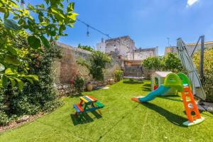 a garden with a castle in the background at Dimora Ferente in Salve