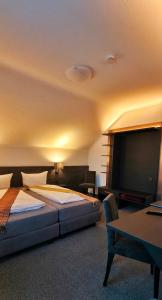 a bedroom with two beds and a flat screen tv at Wilbergerhof RoyalThai in Horn-Bad Meinberg