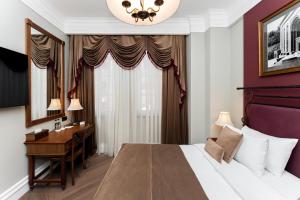 a hotel room with a bed and a desk at Hayasa Hotel Old Yerevan in Yerevan
