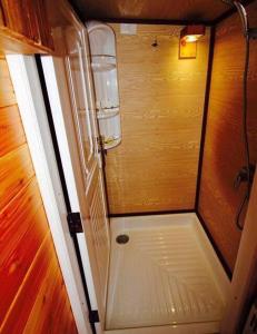 a small shower in a room with a wooden wall at Keereethara chiewlarn in Ban Bang Kaeo +37 photos
