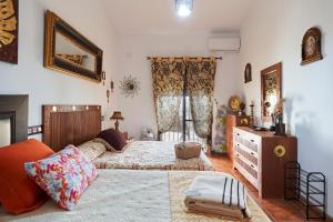 a bedroom with a large bed and a dresser at La Majailla in Peal de Becerro +27 photos