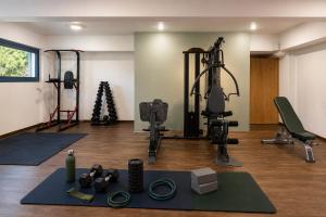 a gym with several exercise equipment in a room at Lagos Mare Hotel in Agios Prokopios