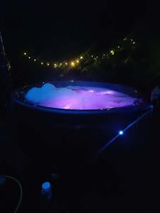 a night shot of a pool with purple lights at Domek z BALIA OGRODOWA in Dłużec +2 photos