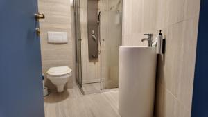 a bathroom with a toilet and a shower with a sink at Black Sea Resort in Eforie Sud