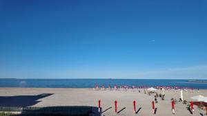 a group of people on a beach with the ocean at Black Sea Resort in Eforie Sud
