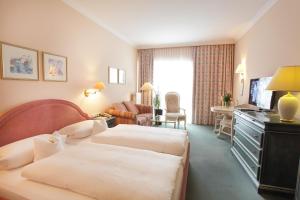 a hotel room with two beds and a television at Aparthotel Alter Weißbräu in Bad Birnbach +44 photos
