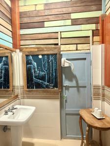 a bathroom with a sink and a door and a table at tamarind guesthouse in Phra Nakhon Si Ayutthaya +60 photos