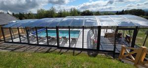 a greenhouse with a pool inside of it at Zbójnicka Chata in Duszniki Zdrój