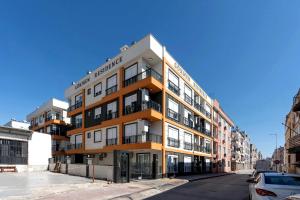 a building on a street with cars parked in front of it at Maxihomes Elissa in Antalya