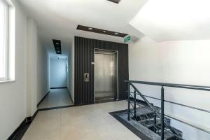 a hallway with a elevator in a building at Maxihomes Elissa in Antalya