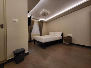 a hotel room with a bed and a television at Hotel Grand Vista in Cochin +21 photos