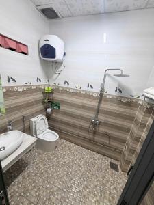 a bathroom with a toilet and a shower stall at Vân Tân Hotel in Kon Von Kla