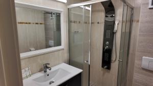 a bathroom with a sink and a shower at Black Sea Resort in Eforie Sud +31 photos