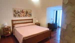 a bedroom with a bed and a painting on the wall at La Piazzetta Alloggio Turistico in Canino