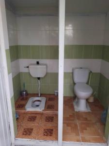 a bathroom with a toilet and a sink in it at Кооператив Радуга in Rasseyka