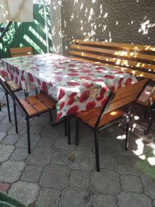 a table and benches with a red and white table cloth at Кооператив Радуга in Rasseyka +4 photos