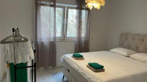a bedroom with a bed with two towels on it at Apartman Anela in Ivanica