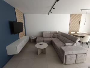 a living room with a couch and a table at Chez nous a Durbuy in Durbuy