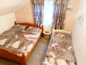 a bedroom with two beds and a window at Casa Naomi in Eforie Nord