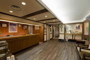 a bar in a barbershop with wood floors and a barber shop at Hakuba Yamano Hotel in Hakuba +130 photos