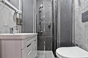 a bathroom with a toilet and a sink and a shower at Denizli Hotel in Istanbul +81 photos