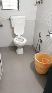 a bathroom with a toilet and a bath tub at Hotel Radha krishna in Neral +7 photos