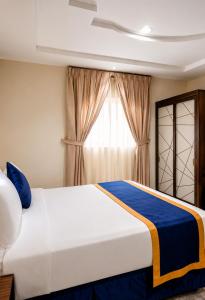 a bedroom with a large bed and a window at Al Quba Palace Serviced Apartments in Riyadh +19 photos