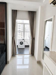 a living room with a washing machine in a room at Modern and quiet Condo BKK1 - Rooftop Pool in Phnom Penh +3 photos