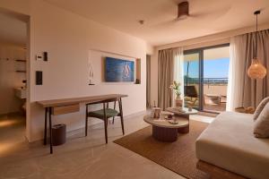 a living room with a table and a couch at Purobeach Resort Santa Ponsa in Santa Ponsa