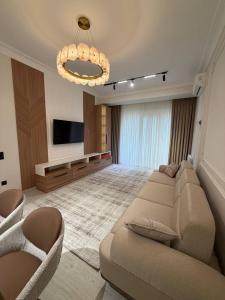 a living room with a couch and a flat screen tv at Top1 Gardens Residents in Tashkent