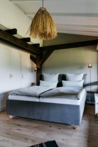 a bedroom with a large bed and a chandelier at Chiemgau Nest II in Siegsdorf
