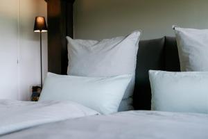 a bedroom with two beds with white pillows at Chiemgau Nest II in Siegsdorf