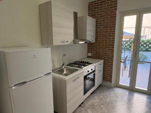 a kitchen with a white refrigerator and a sink at Chill House Reggio Calabria in Reggio di Calabria