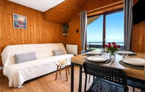 a living room with a couch and a dining room table at Vue Lac Léman & Télécabine à 1 minute in Thollon +31 photos