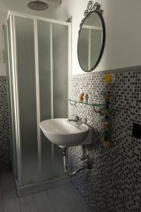 a bathroom with a sink and a shower with a mirror at Monastero Retreat - Villa con SPA in Lanzo dʼIntelvi +24 photos