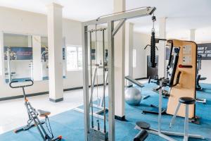 a gym with treadmills and exercise equipment at Hotel Puri Indah & Convention in Tjakranegara