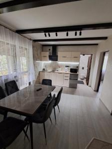 a kitchen and dining room with a table and chairs at Вершина Мрій in Slavske