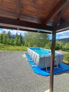 a hot tub sitting under a roof at Вершина Мрій in Slavske