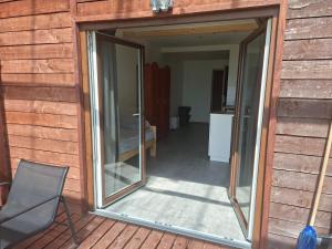 a sliding glass door on the side of a house at J&L Lake Resort in Grądzkie
