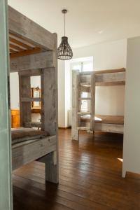 a room with two bunk beds and a pendant light at Monastero Retreat - Villa con SPA in Lanzo dʼIntelvi
