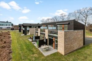 an image of a house in a field at Lübker Golf Resort in Nimtofte